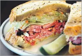  ?? Kirk McKoy Los Angeles Times ?? THE NO. 19 at Langer’s: pastrami, coleslaw, Russian dressing and Swiss cheese.