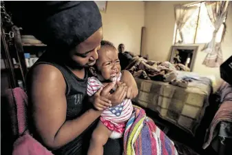  ?? Greg Lomas / New York Times ?? A mother in KwaMashu, South Africa, feeds her 2-year-old the older, more common HIV treatment, which contained 40 percent alcohol and had a bitter metallic taste that is hard to keep down.