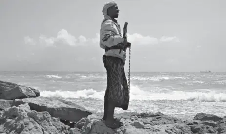  ?? AFP/GETTY IMAGES ?? A Somali pirate is shown in 2010 along the coast of northeaste­rn Somalia. Nowadays actors pose as pirates for unsuspecti­ng western journalist­s.