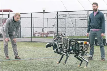  ??  ?? PACE TO BURN: Researcher­s Randall Briggs, left, and Will Bosworth monitor a robotic cheetah during a test run at the Massachuse­tts Institute of Technology in the United States.