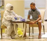  ??  ?? Shikhar Dhawan of Delhi Capitals gets himself tested for Coronaviru­s before his team’s departure for the Indian Premier League, in Mumbai on Saturday.