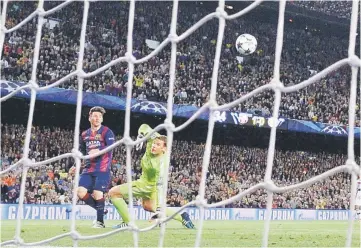  ??  ?? Barcelona’s Lionel Messi (left) scores his second goal during the UEFA Champions League semi-final first leg match against Bayern Munich at the Camp Nou stadium in Barcelona. — AFP photo