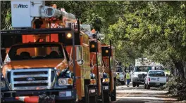  ?? GREG LOVETT / THE PALM BEACH POST ?? Danella power and Asplundh Tree Expert Co. trucks line Lake Avenue in West Palm Beach’s Flamingo Park on Wednesday. FPL expects power to be restored to all its Palm Beach County customers by the end of the weekend.