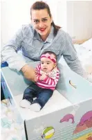  ?? Picture / AP ?? Dolores Peterson and her 3-monthold daughter Ariabella in Camden, New Jersey, with a baby box.