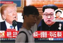  ?? (Kim Hong-Ji/Reuters) ?? A MAN walks past a TV broadcast of the news yesterday in Seoul.