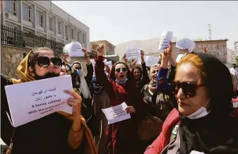  ?? Wali Sabawoon / Associated Press ?? Women gather near the presidenti­al palace in Kabul to demand equal rights from the new Taliban rulers. Many Afghans fear a rollback of rights gained over the past two decades.