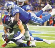  ?? Paul Sancya / Associated Press ?? Giants tight end Rhett Ellison is tackled by Lions middle linebacker Jarrad Davis, top, during the second half on Sunday.