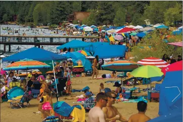  ??  ?? PHOTO BY RAY CHAVEZ — STAFF ARCHIVES Beachgoers cool off at Kings Beach State Recreation Area on Aug. 16. COVID-19 herd immunity may be difficult to reach, in part because of vaccine hesitancy, vaccines are not fully effective and new variants have emerged.