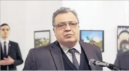  ?? BURHAN OZBILICI/AP ?? Just before Monday’s shooting, Andrei Karlov, Russia’s ambassador to Turkey, speaks at a gallery in Ankara. The gunman is seen at rear on the left.