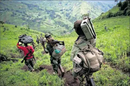  ?? ?? Endless: From top) In the 1990s the
DRC’S Laurentdés­iré Kabila (top left) asked Zimbabwe’s Robert Mugabe (top right) for help. Today, M23 rebels (above) are fighting in eastern DRC. Internally displaced people seek refuge in Bijombo camp (left).