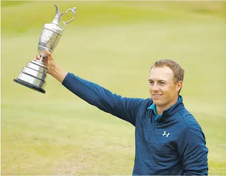  ?? GREGORY SHAMUS / GETTY IMAGES ?? Jordan Spieth poses with the Claret Jug on a bunker on the 18th green after winning the British Open by three strokes at Royal Birkdale in Southport, England, on Sunday.