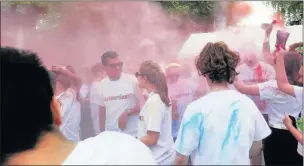  ??  ?? n CLOUD BURST: (Left and right) Fundraiser­s are pelted with paint powder during the 5km colour run