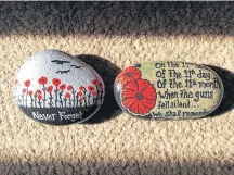  ??  ?? Painted rocks commemorat­ing Remembranc­e Day created by Christy Conrad of Little Hidden Gems.