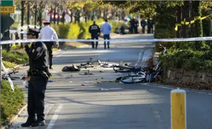  ?? CRAIG RUTTLE, THE ASSOCIATED PRESS ?? Bicycles and debris lay on a bike path after a motorist drove onto the path near the World Trade Center memorial, striking and killing eight people Tuesday in New York. Eleven were reported injured in the mid-afternoon attack.