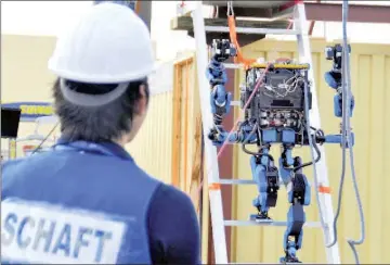  ??  ?? In one brief clip, ithe robot appears to be cleaning stairs with an attachment on one of its feet.The robot was developed by Schaft, a Japanese subsidiary of Google’s labs. — Schaft photo