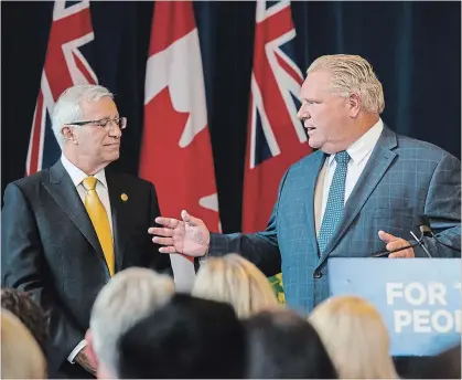  ?? CHRISTOPHE­R KATSAROV THE CANADIAN PRESS ?? Ontario Finance Minister Vic Fedeli, left, looks on as Premier Doug Ford speaks to members of his caucus in Toronto on Monday.