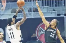  ?? Tony Dejak / Associated Press ?? Brooklyn's Kyrie Irving shoots over Cleveland’s Isaac Okoro in the first half Wednesday. Irving was 15-for-28 from the field and 3-for-8 from 3-point range. Kevin Durant had 38 points to lead Brooklyn.