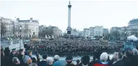  ?? (Stefan Wermuth/Reuters) ?? PEOPLE ATTEND a vigil in London’s Trafalgar Square yesterday.