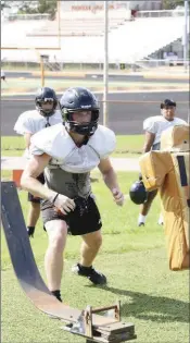  ??  ?? Junior fullback/defensive lineman Gentry Moody practices his blocking for Batesville.