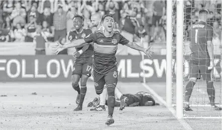  ?? Leslie Plaza Johnson ?? Dynamo midfielder Memo Rodriguez celebrates his game-winning goal against the Galaxy and goalkeeper David Bingham, right.