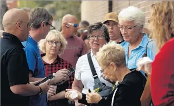  ??  ?? RESIDENTS wait in line at a Federal Emergency Management Agency hub Sunday in Santa Rosa.