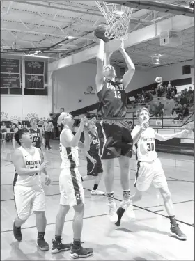  ?? NWA Democrat-Gazette/MIKE ECKELS ?? Omaha’s Garrett Matlock (13) drops in a layup Tuesday against Decatur in Decatur.