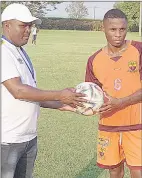  ?? ?? Young Buffaloes’ Bongwa ‘Owa’ Matsebula, receiving a ball from Premier League of Eswatini Match Coordinato­r Vusi Sukati as an incentive for his hat-trick yesterday.