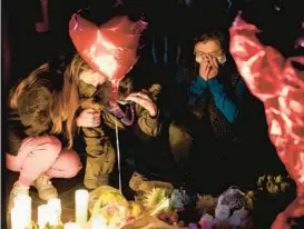  ?? ASHLEY LANDIS/AP ?? Mourners attend a vigil last week at a makeshift memorial honoring the victims of a Jan. 21 mass shooting at the Star Ballroom Dance Studio in Monterey Park, Calif.