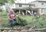  ?? WAYNE CUDDINGTON / POSTMEDIA NEWS ?? Volunteers, including Peggis Slavin, came to help clear debris from Tracey Graham’s Ottawa home.