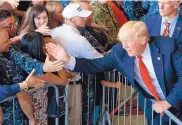  ?? EVAN VUCCI/ASSOCIATED PRESS ?? President Donald Trump greets people after speaking to U.S. military troops at Naval Air Station Sigonella on Saturday in Italy. A staff shake-up is being considered to help deal with the Russian investigat­ion crisis.