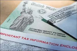  ?? Eric Gay The Associated Press ?? President Donald Trump’s name is printed on an Economic Impact Payment check issued by the IRS to help combat the effects of the coronaviru­s outbreak.