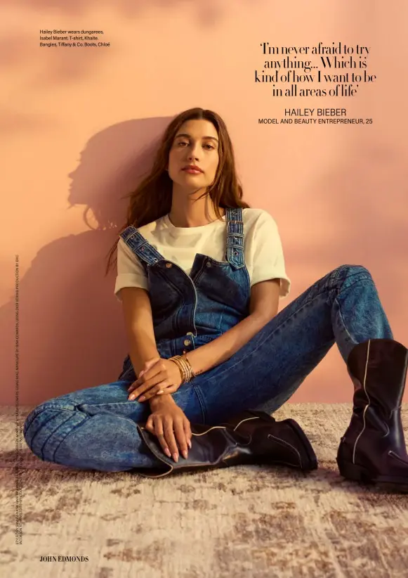  ?? ?? Hailey Bieber wears dungarees, Isabel Marant. T-shirt, Khaite. Bangles, Tiffany & Co. Boots, Chloé