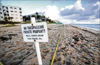  ?? LANNIS WATERS / DAILY NEWS ?? Beginning July 1, local government­s won’t be able to force private beach owners to allow surfers, sunbathers and shell seekers on their parcel of sand with just a vote.