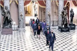  ??  ?? House Sergeant of Arms (front) walks with House impeachmen­t managers to the Senate floor as they arrive for the start of the trial of former US President Donald Trump on Capitol Hill, in Washington, DC