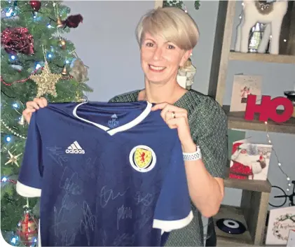  ??  ?? David Hagen’s sister, Kirstin Horner, shows off the signed Scotland top that will now take its place in his hospice room alongside the others from his club days. David played with (clockwise from top left) Rangers, Hearts, Falkirk, Livingston, Clyde and Peterhead