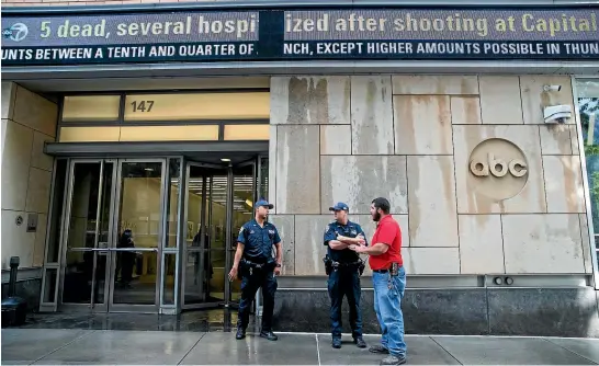  ?? AP ?? Police officers stand guard outside the ABC studio yesterday in New York. The New York Police Department has sent patrols to major news media organisati­ons in response to the shooting at The Capital Gazette ,a newspaper in Annapolis, Maryland.