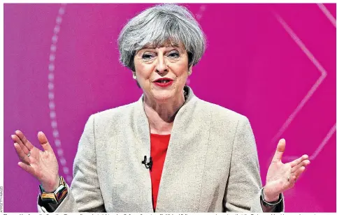  ??  ?? Theresa May faces the Question Time audience last night, as her Defence Secretary, Sir Michael Fallon, was reassuring voters that the Tories would not increase income tax