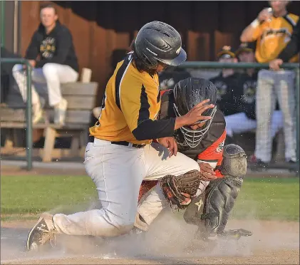  ?? STEVEN MAH/SOUTHWEST BOOSTER ?? Swift Current 57’s catcher Luis Navarrro (right) prevented Moose Jaw’s Dougie Delacruz from scoring during a 7-6 win over the visiting Miller Express on Saturday.