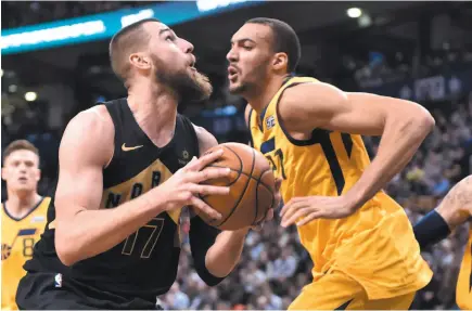  ?? CP PHOTO ?? Toronto Raptors centre Jonas Valanciuna­s eyes the basket while going against Utah Jazz defender Rudy Gobert on Friday night in Toronto.