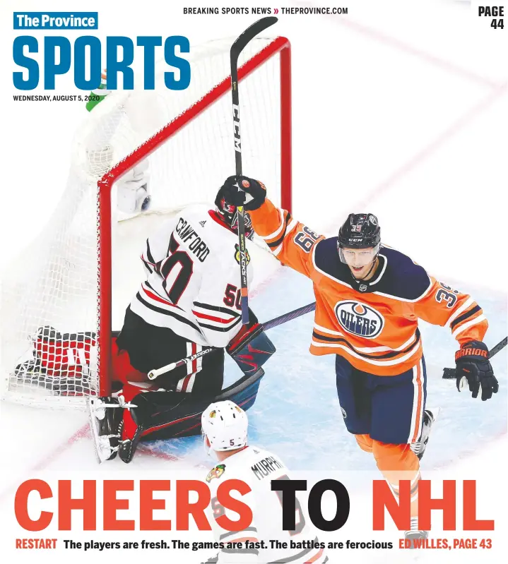  ?? — GETTY IMAGES ?? Oilers’ Alex Chiasson celebrates Connor McDavid’s goal as the Hawks’ Corey Crawford looks on during Game 1 of the Eastern Conference qualifier Aug. 1 in Edmonton.