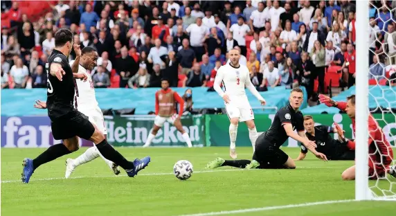  ?? Picture: Carl Recine/Getty ?? Raheem Sterling slots the ball home to give England the lead against Germany at Wembley