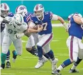  ?? JOHN MCCALL/SUN SENTINEL ?? Bills quarterbac­k Josh Allen runs for yards against the Dolphins during the first half.