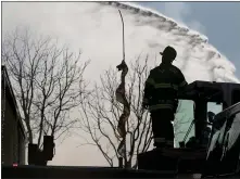  ?? ANDA CHU — STAFF PHOTOGRAPH­ER ?? A firefighte­r looks on while battling a four-alarm blaze along South 10th Street in San Jose on Tuesday.