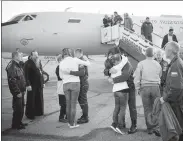  ?? BILL INGALLS / NASA VIA REUTERS ?? Russian cosmonaut Aleksey Ovchinin and US astronaut Nick Hague embrace their families after the Soyuz emergency landing in Baikonur, Kazakhstan, on Thursday.