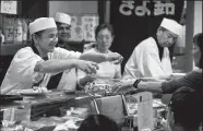  ?? BRIAN VAN DER BRUG/TRIBUNE NEWS SERVICE ?? Sushi chef and owner Kiyoto Nagasu, left, serves guests at his Japanese restaurant Kiyosuzo in Arcadia on February 17. His daughter, U.S. Olympic figure skater Mirai Nagasu, landed a triple axel on Monday night, making history and securing a bronze...