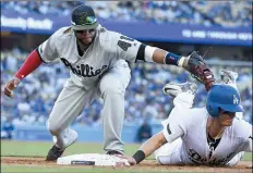  ?? THE ASSOCIATED PRESS FILE ?? If Baseball deems a 50- or even 60-game season appropriat­e, ponder the possibilit­y of the Dodgers’ Cody Bellinger, right in this shot of a game against Carlos Santana and the Phillies two years ago, becoming the next Ted Williams.