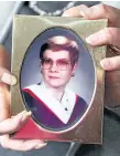  ?? CHERYL CLOCK/STANDARD STAFF ?? Linda Crabtree, The Standard's columnist and disability advocate, holds her graduation photo from Brock University in 1987.