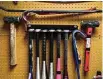  ?? Patrick T. Fallon/AFP via Getty Images ?? Various tools including sledgehamm­ers and crowbars hang outside a rage room.