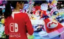  ?? Kyung Hoon/Reuters ?? The Nintendo Switch games console has sold almost 1m units, making it the thirdbests­elling of all time. Photograph: Kim