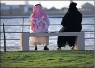  ?? HASAN JAMALI/THE ASSOCIATED PRESS ?? A Saudi couple sit on a bench overlookin­g the sea, in Jiddah, Saudi Arabia. As society changes in Saudi Arabia, women are challengin­g the rules on how to meet a prospectiv­e husband.